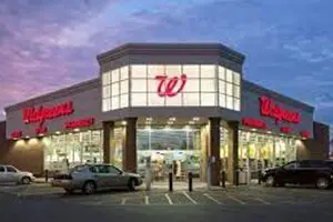 A walgreens store with cars parked in front of it.