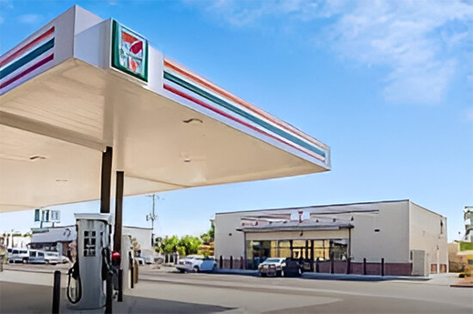 A gas station with cars parked on the side of it.